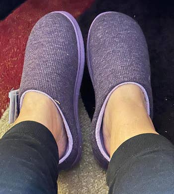 Person wearing purple comfy slippers