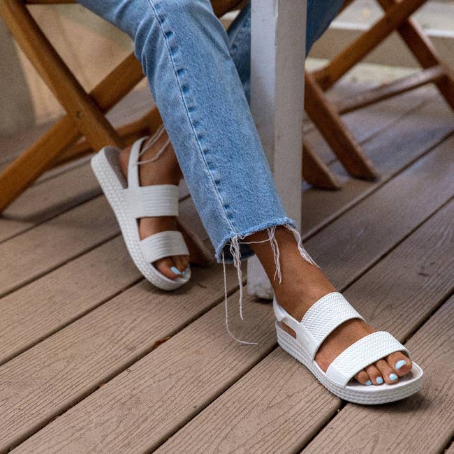Model is wearing the white platform sandals