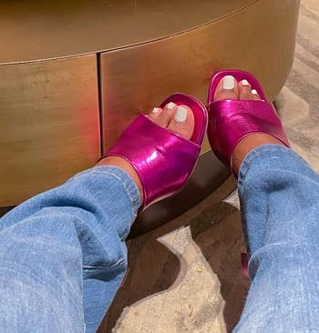 reviewer wearing the pink metallic mules with jeans