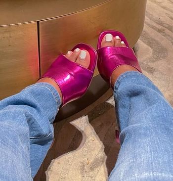 reviewer wearing the pink metallic mules with jeans