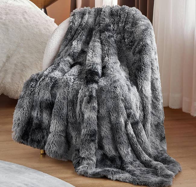gray faux fur blanket on a chair