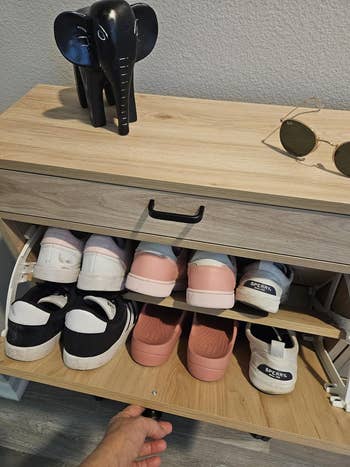 reviewer showing the drawer open with shoes inside