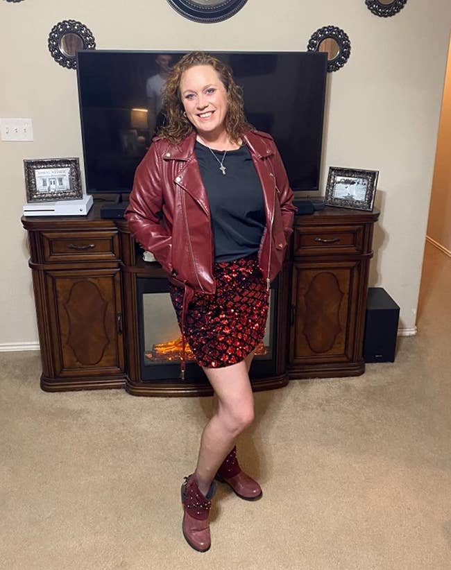reviewer in red cropped faux leather moto jacket and sequin skirt