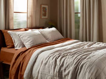 Bed with neatly arranged bedding and pillows, suitable for home decor inspiration