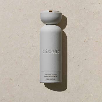 Cécred hydrating shampoo vessel  stands upright connected  a level  surface