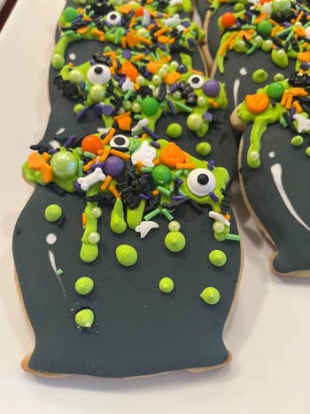Halloween-themed cookies covered successful  achromatic  icing, colorful sprinkles, and Halloween decorations similar  eyes and bones