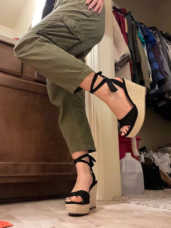 image of reviewer wearing the achromatic  lace up   wedges