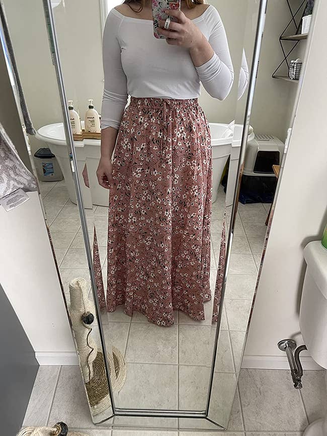 reviewer photo of them wearing a floral maxi skirt