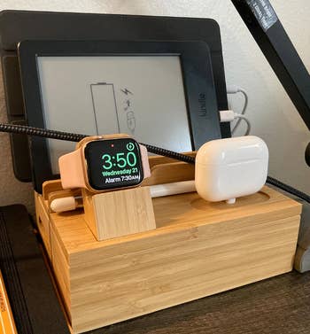 reviewer image of dock charging earbuds, a watch, and an ipad