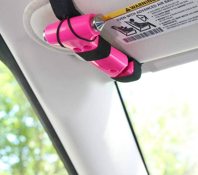 the pink escape hammer tool clipped to car visor