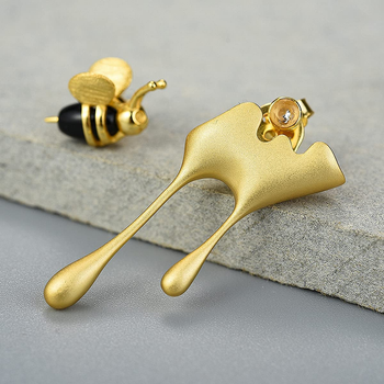 gold bumblebee stud and ear jacket that goes around ear and looks like dripping honey, with front stud