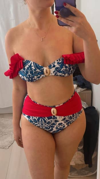 Person taking a reflector  selfie wearing an off-shoulder bikini with a patterned plan  and a decorative ammunition  detail, suitable for a buying  article