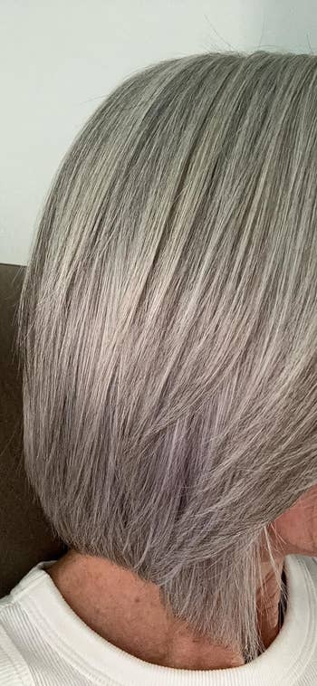 Close-up of a person's smooth gray hair from the side