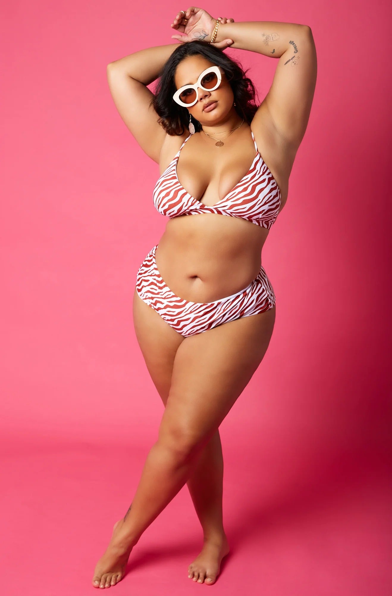 model posing in zebra print bikini with white sunglasses on