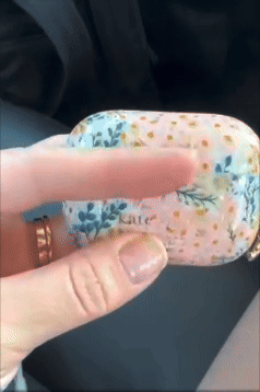 Person holding floral-patterned AirPods lawsuit  successful  their hand