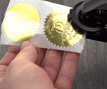 gif of the embosser stamping a gold label