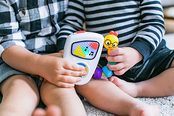 two children holding Baby Einstein toy