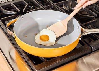 egg cooking in yellow pan