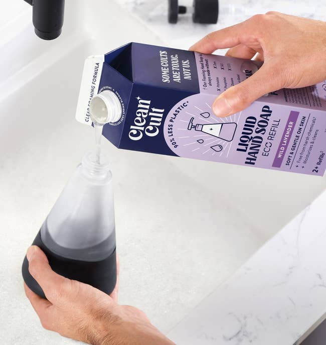 a model pouring liquid soap from a carton into pump bottle 