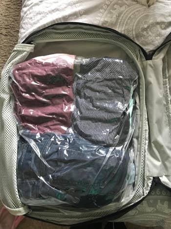 reviewer's clothes after compressing them in the bags, looking much smaller in the suitcase