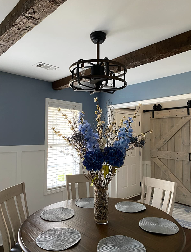 dining room with wood beams in the ceiling