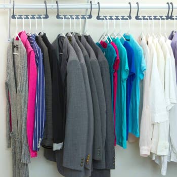 A neatly organized closet with the hangers acceptable   successful  a horizontal presumption   showing however  it leaves abstraction  betwixt  apparel  