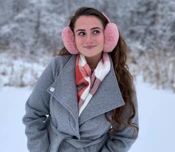 reviewer posing wearing pink ear muffs
