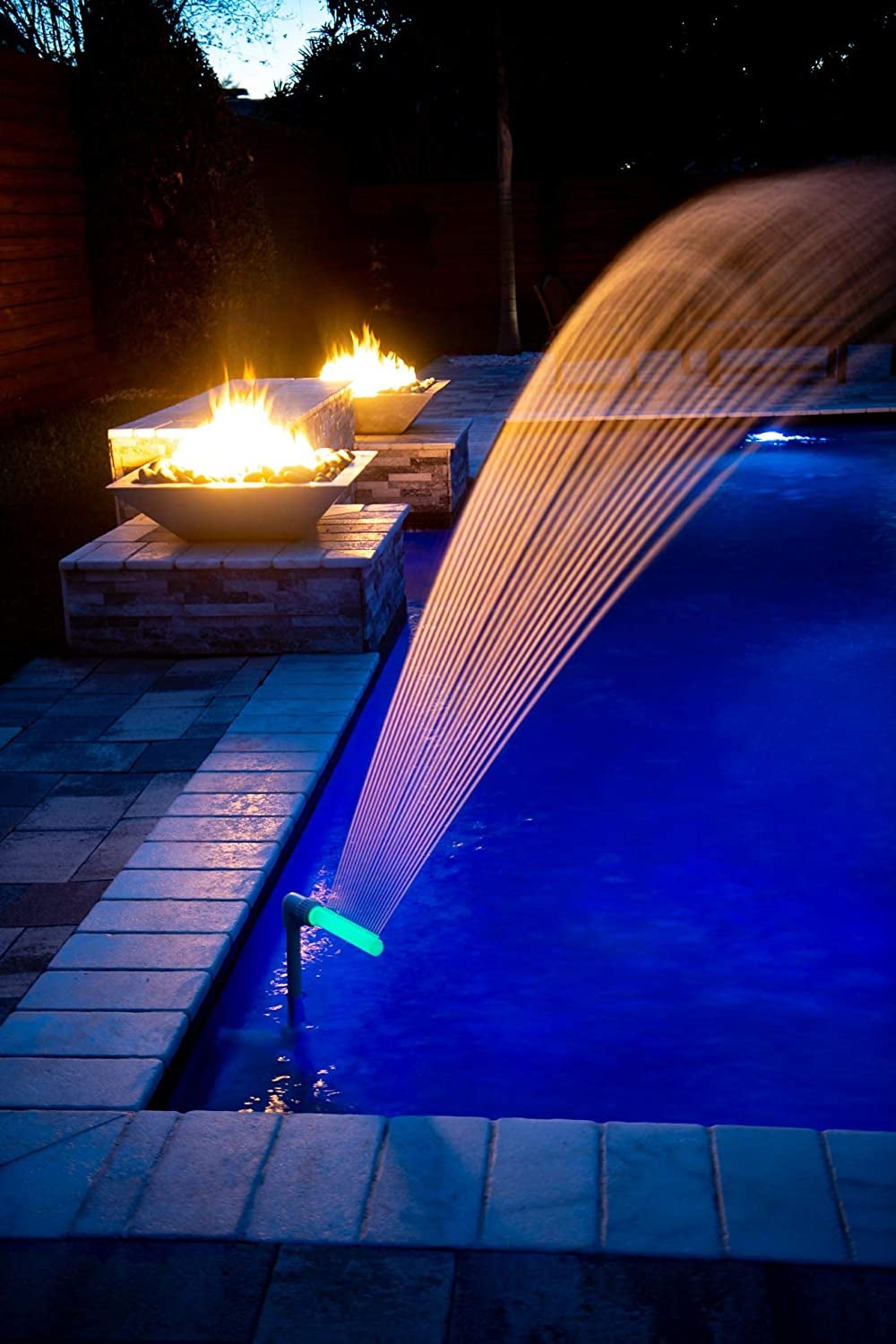 corner of pool with light water fountain spouting water 