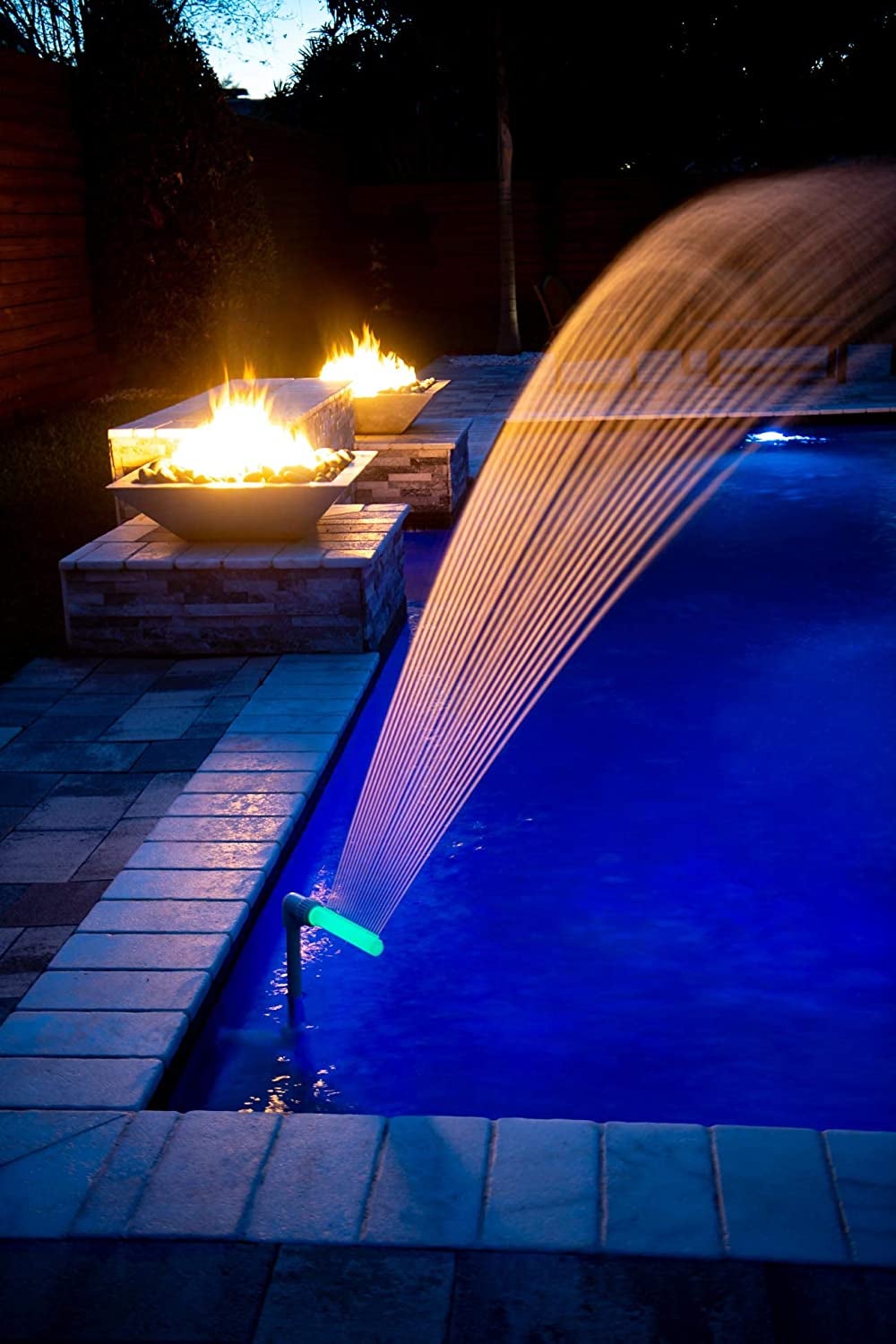 corner of pool with light water fountain spouting water