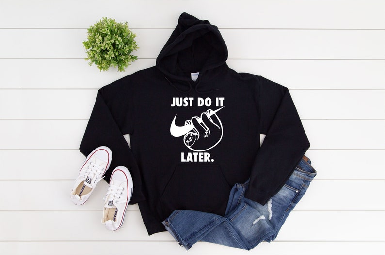 black hoodie with white graphic of sloth hanging off nike logo with text