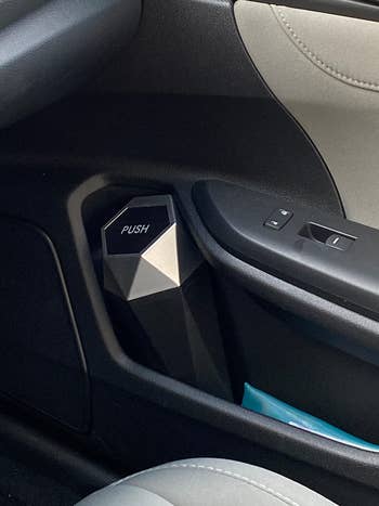 the mini trash can in the door cupholder of a reviewer's car