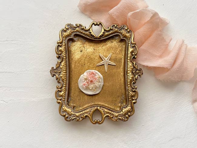 Antique-style frame with a cameo and starfish brooch, a piece of vintage-inspired jewelry