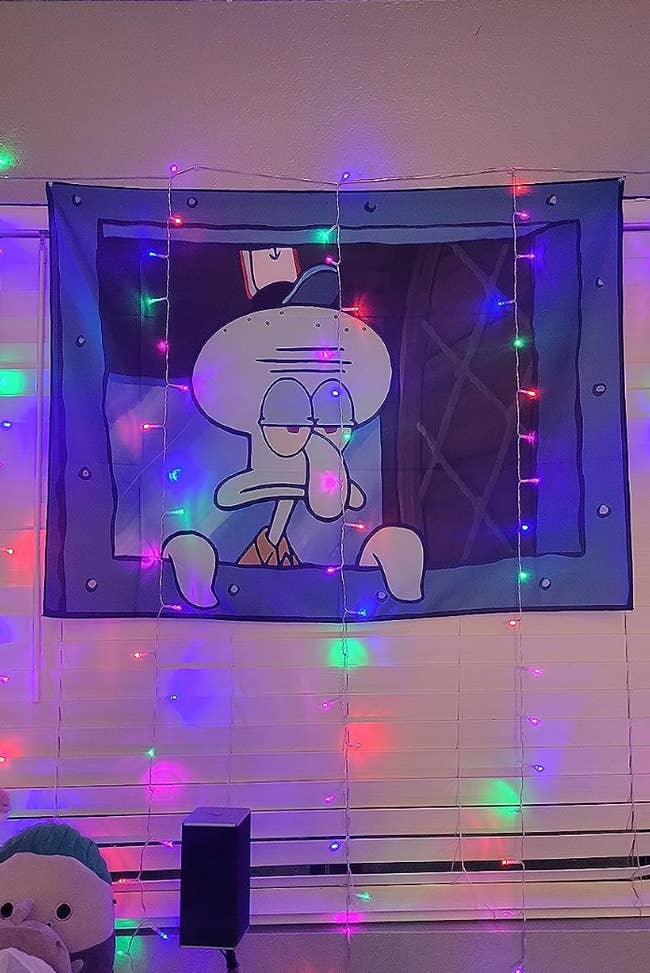tapestry of Squidward standing unenthused at the ordering window of the Krusty Krab 