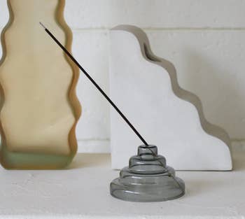 A gray amber glass incense holder