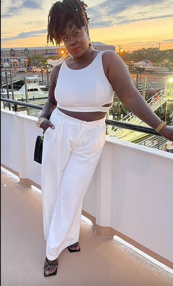 reviewer in white high waisted wide leg pants 
