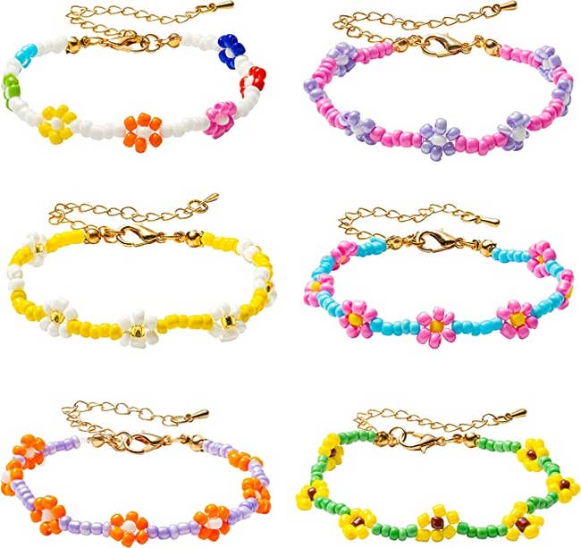 Six daisy beaded bracelets in purple, orange, green, yellow, blue, pink, and white