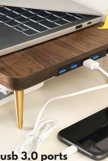 a close up of the usb ports on the dark wood riser