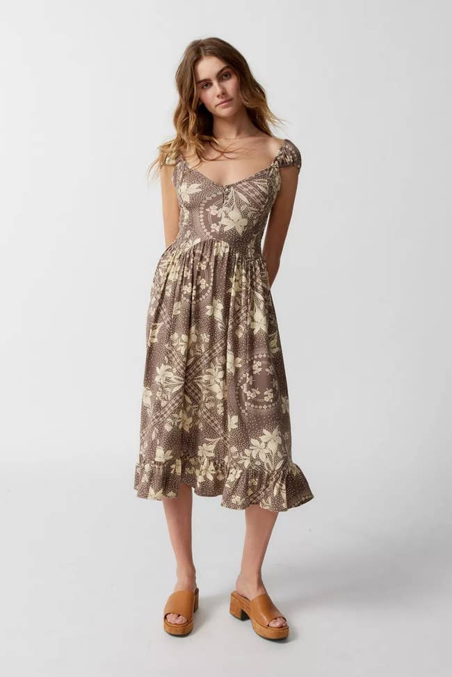 model wearing brown printed midi dress with sandals
