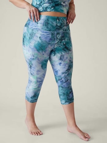 model wearing the blue and green printed leggings