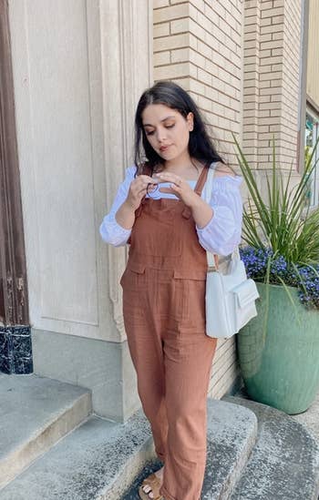 a reviewer wearing the brown overalls
