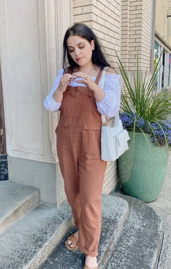 a reviewer wearing the brown overalls