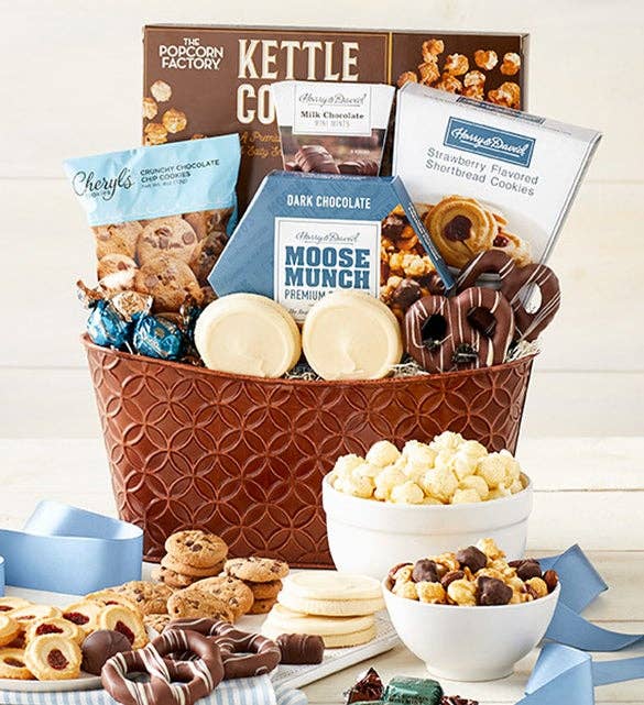 Gift basket with popcorn, cookies, chocolates, and candies. Includes brands like The Popcorn Factory and Moose Munch. Featured in shopping article