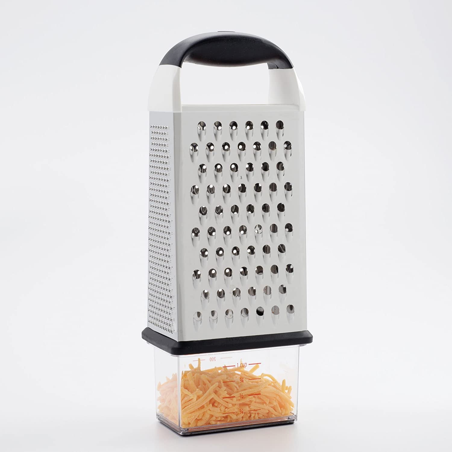 a product photo of the grater on top of the measuring cup it comes with