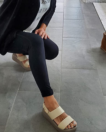 reviewer wearing the beige sandals