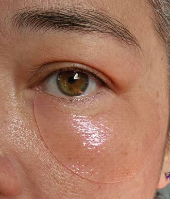 Close-up of a person wearing a hydrating under-eye patch, showcasing skincare for reducing puffiness or dark circles