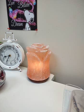 reviewer's lamp softly lit in a bright room