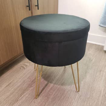 reviewer's black storage ottoman with the top on