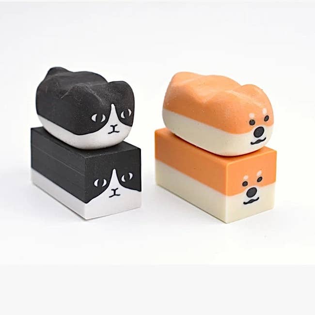 cat and shiba erasers sitting on top of cubed versions of them