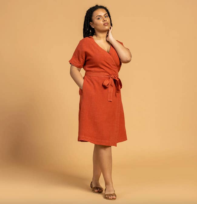 a model wearing the cinnamon red dress