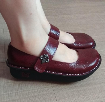 Reviewer wearing burgundy shoes